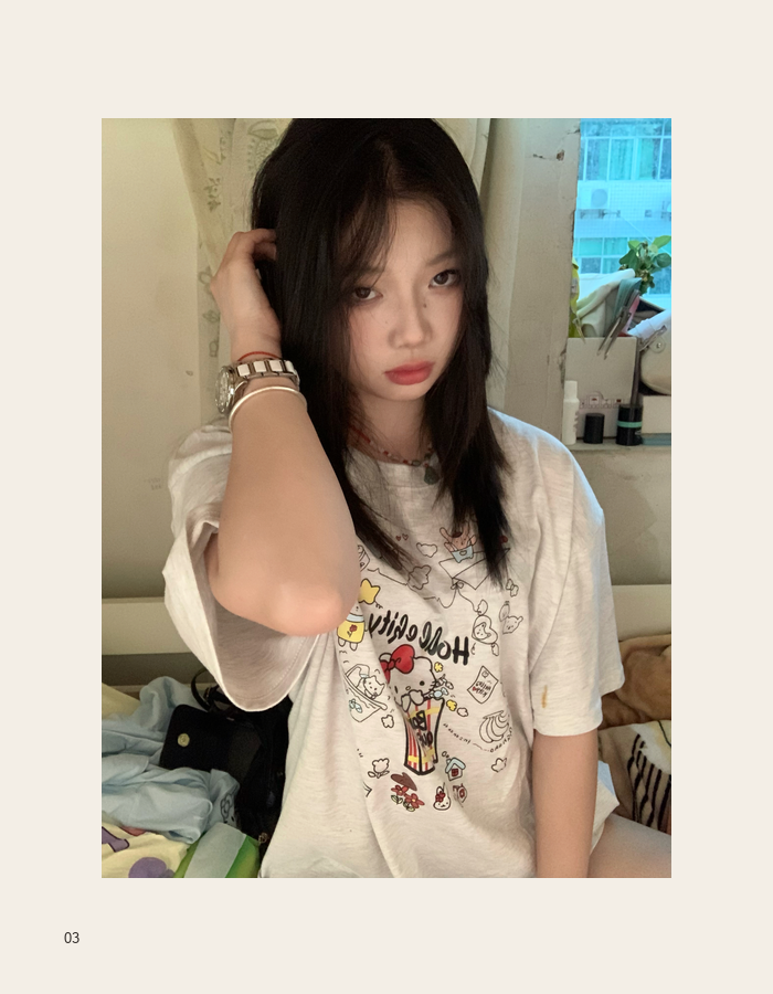 Seated casual portrait in a cream T-shirt