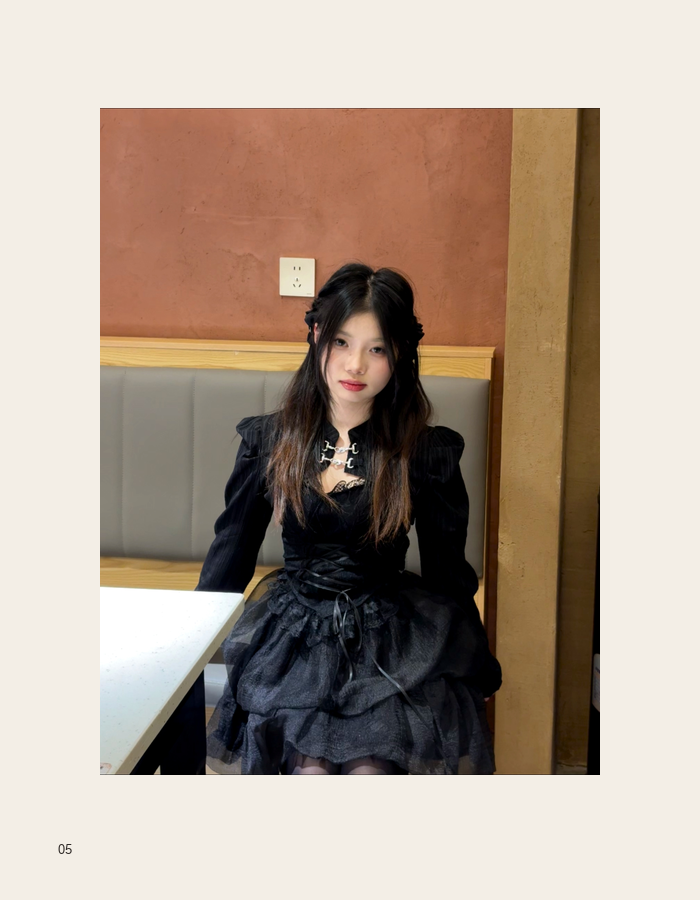 Black dress portrait seated in a warm interior