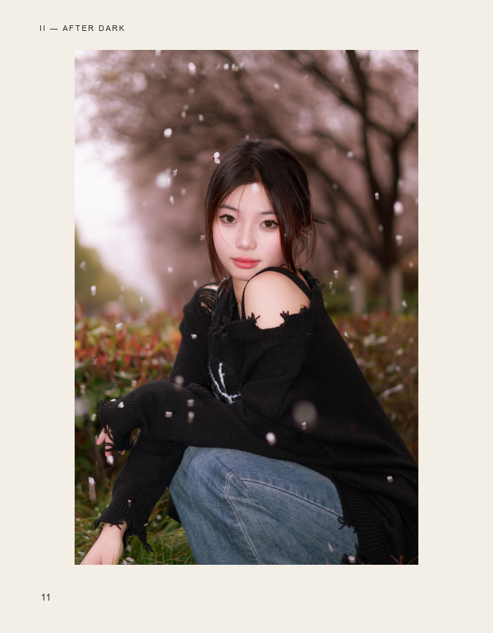 Black portrait beneath softly blooming trees