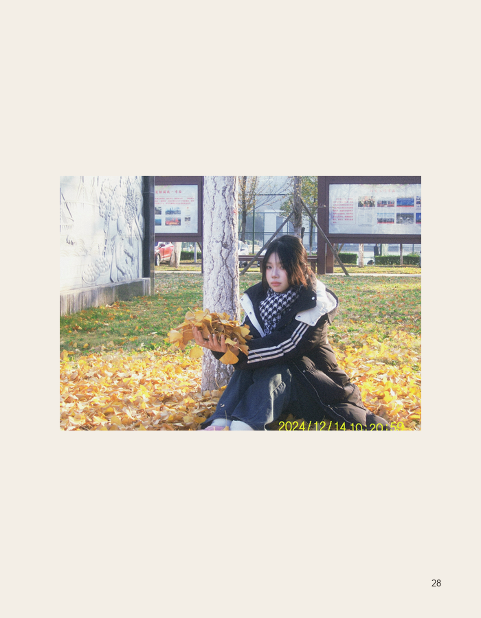 Seated portrait among fallen leaves