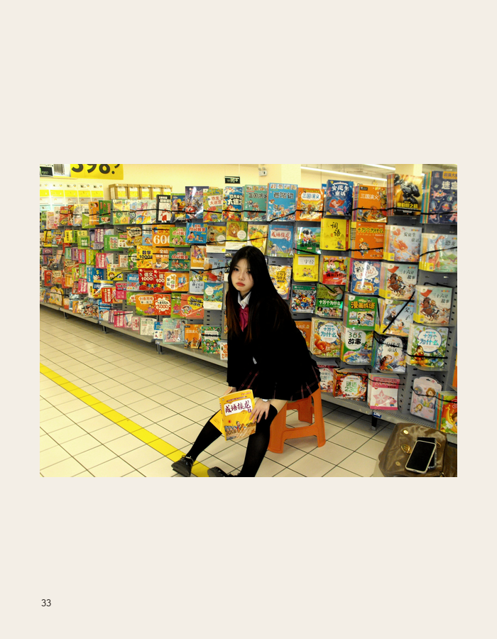 Portrait seated before colorful supermarket packages