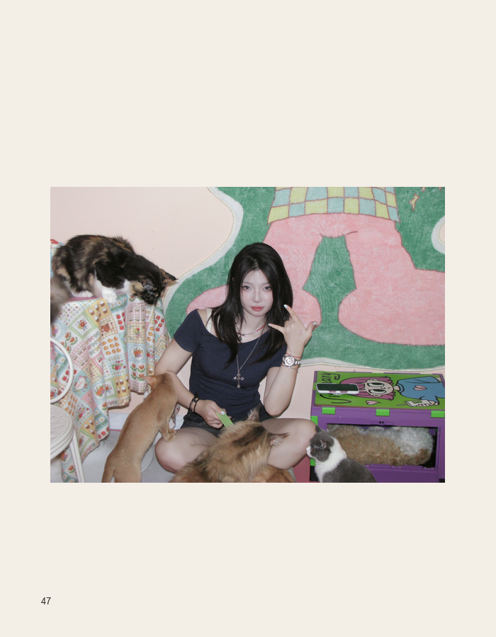 Indoor portrait with cats and a colorful mural