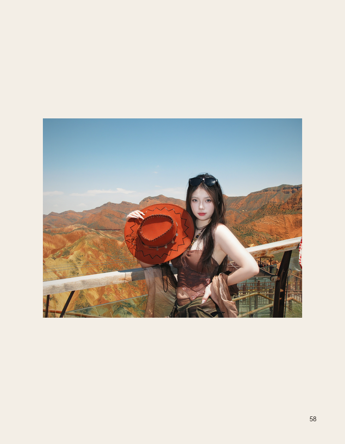 Portrait with a terracotta hat against mountain ridges